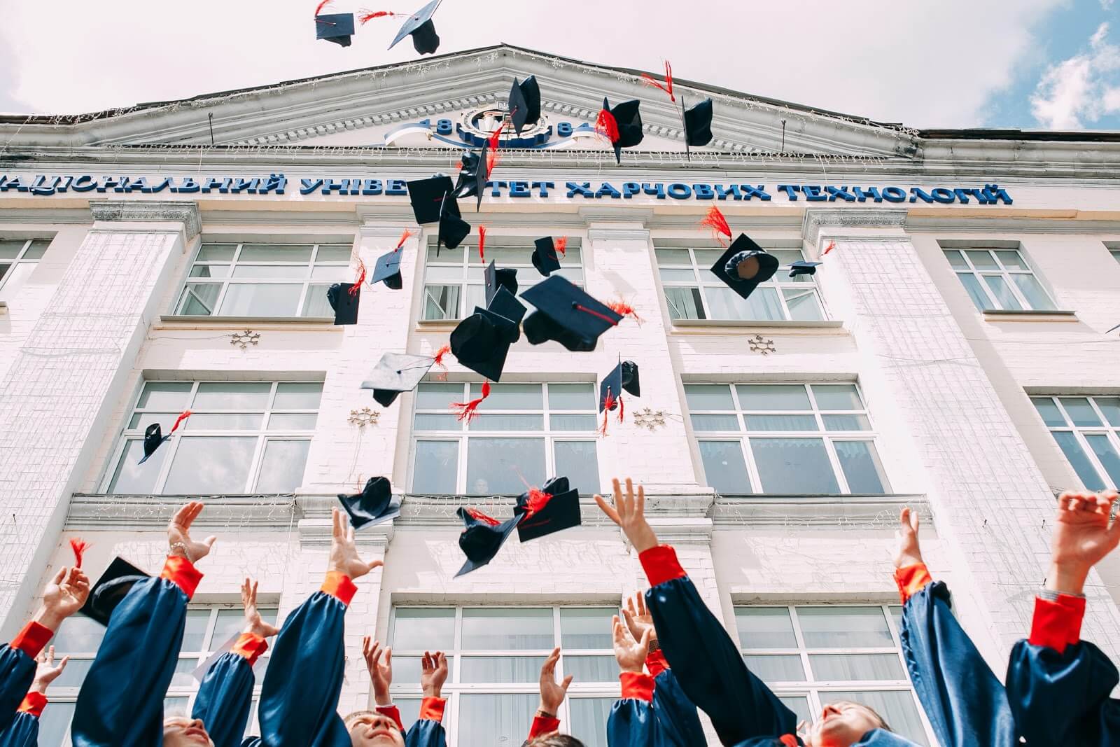 students throwing caps at graduation college