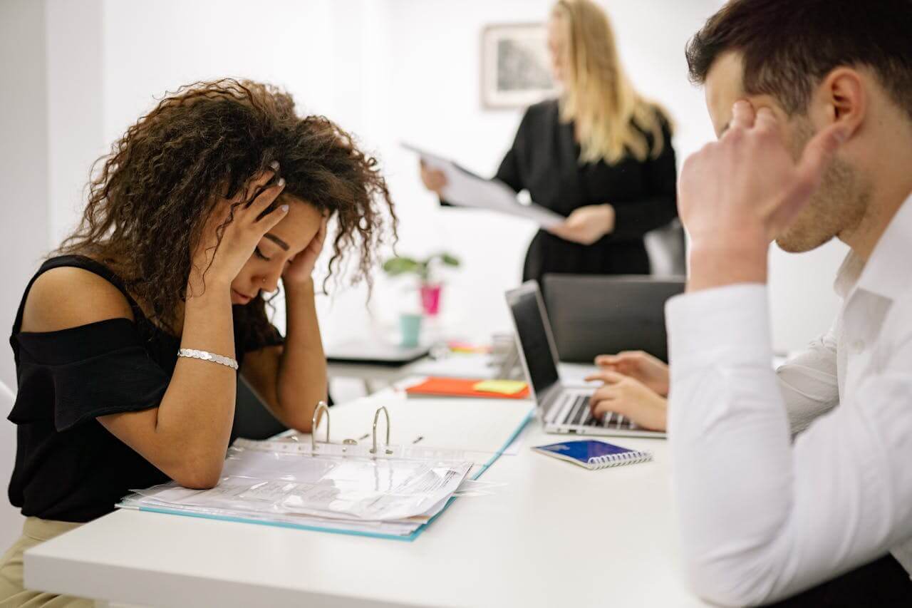 Two professionals sit at a conference table