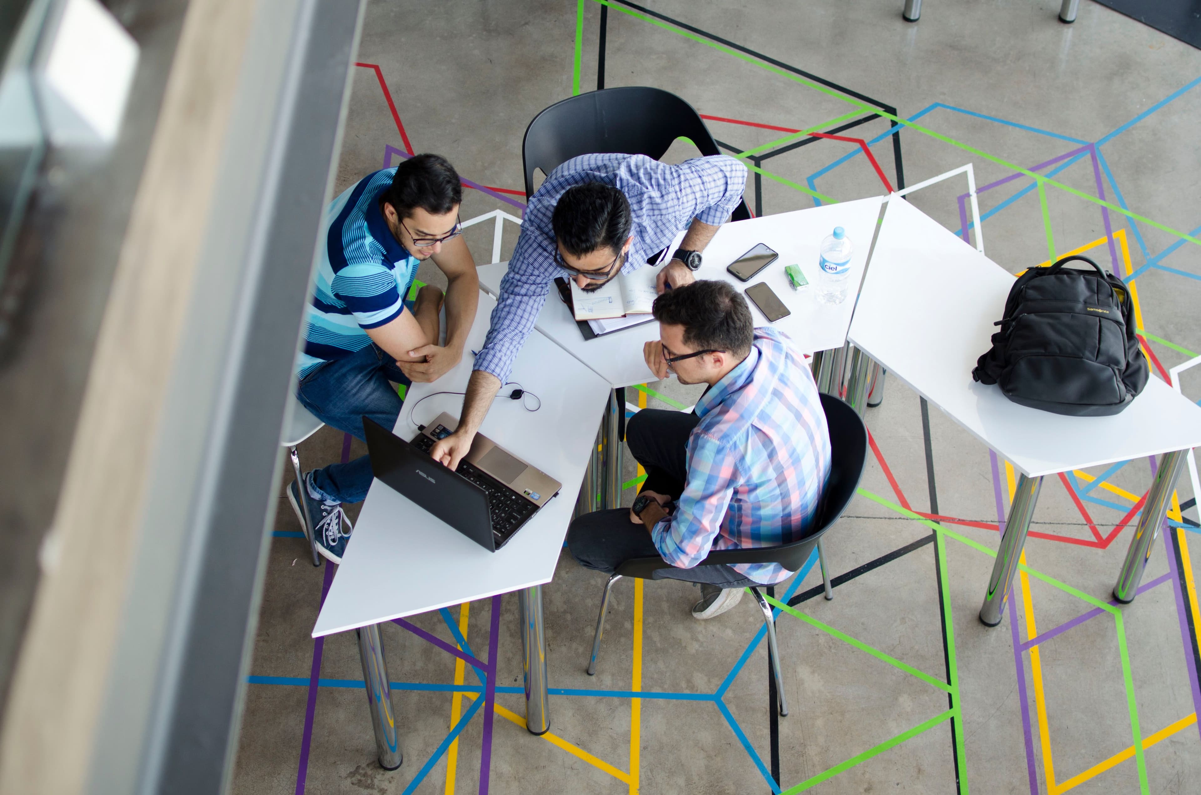 male employees in group mentoring session: employee engagement strategy