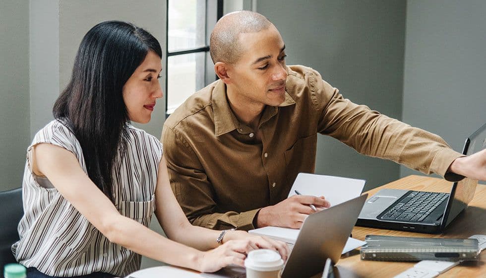 two-coworkers-looking-at-computer